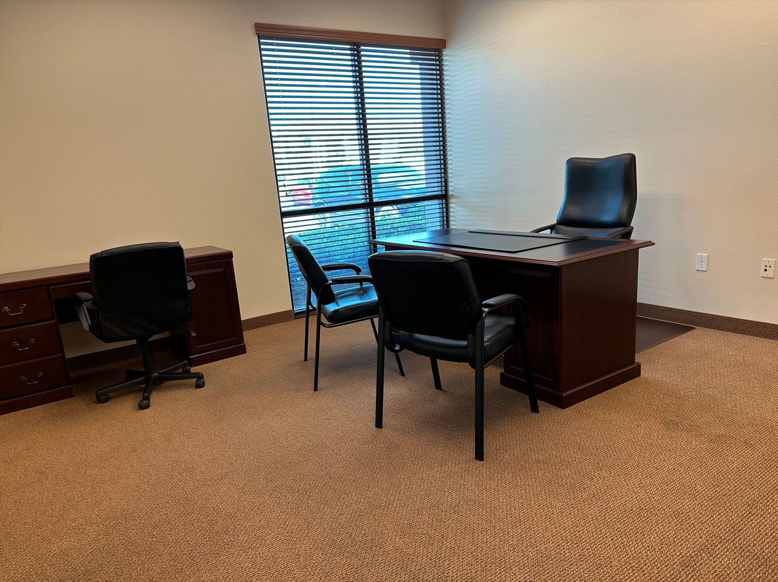 Private Office Space with window, desk, and chairs